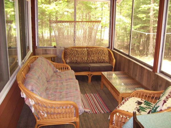 Screen porch with comfortable wicker furniture
