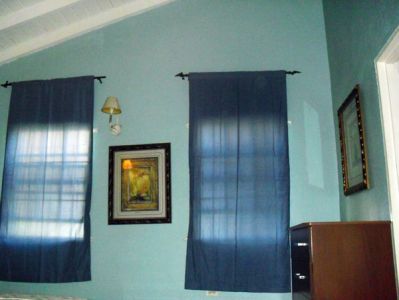 Room with blue curtains and chest of drawers