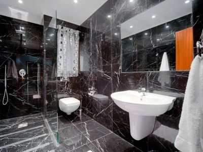 Bathroom with black marbled tiles
