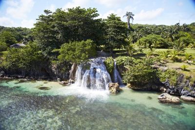 View of garden waterfall cascading into sea