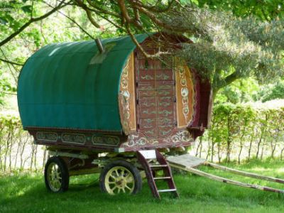 Bow top gypsy caravan in orchard