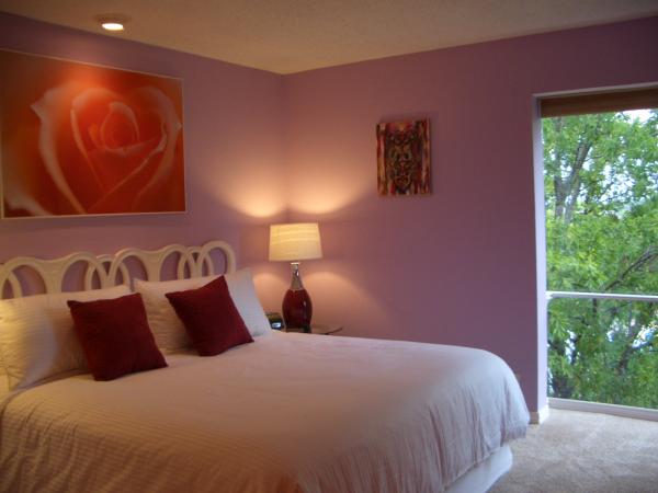Bedroom has king bed, large window & heart art