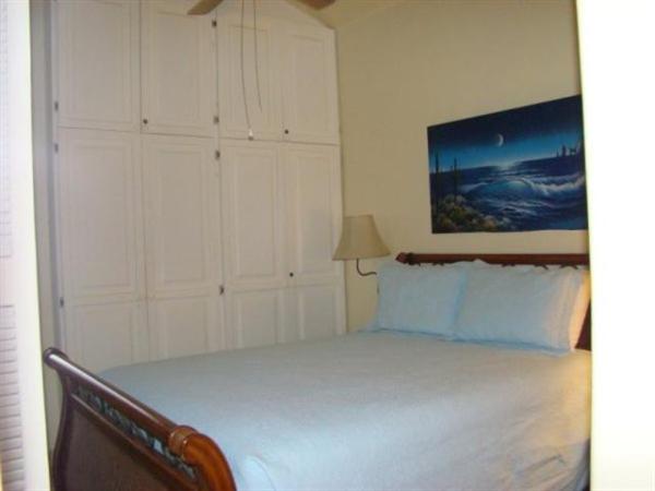 Closet, night stands, & ceiling fan in Bedroom