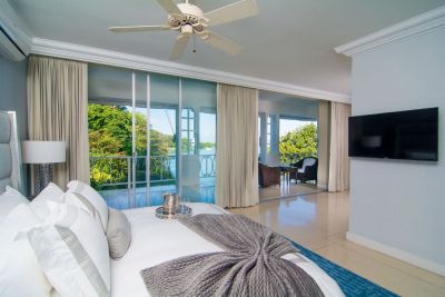 Bedroom with patio and view of sea