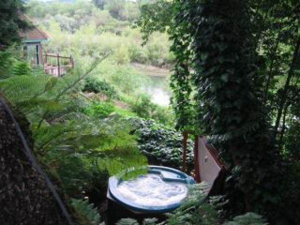Secluded hot tub overlooks river