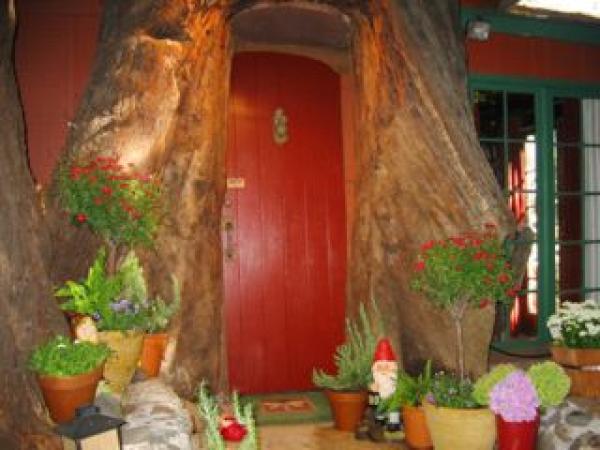 Charming entry through redwood trunk