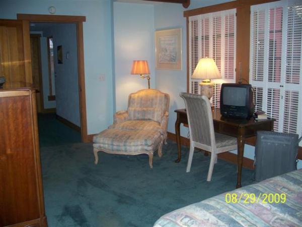 Bedroom with queen bed, reading area & small desk