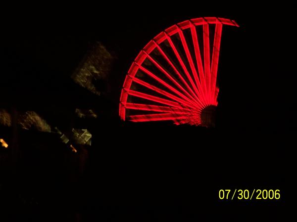 View of ferris wheel at night from deck