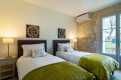 Twin bedroom with access to private patio area