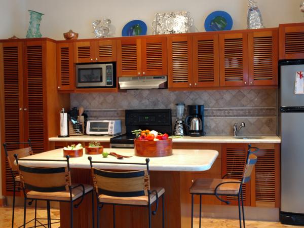 Kitchen has center island, opens to balcony