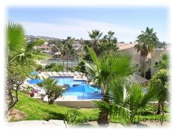 A View of 1 of 2 pools with a swim up bar