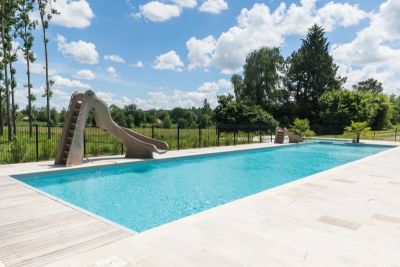 Heated swimming pool with two slides 